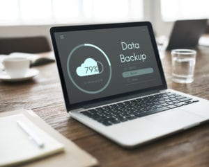 image of mac computer with loading data backup screen
